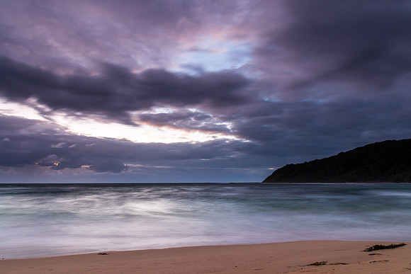 Moody morning bay seascape with rain clouds