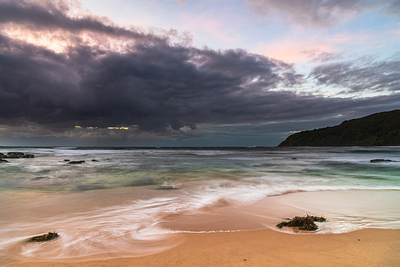 Moody morning bay seascape with rain clouds