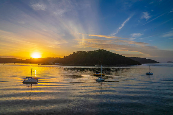 Aerial sunrise waterscape with boats
