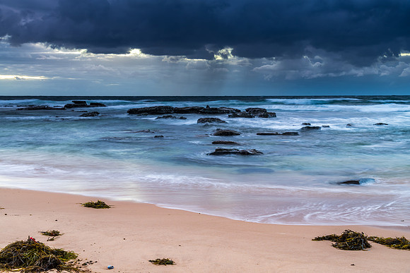 Moody morning bay seascape with rain clouds