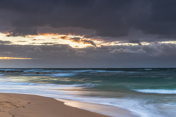 Moody morning bay seascape with rain clouds