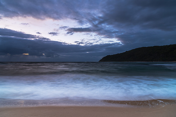 Moody morning bay seascape with rain clouds
