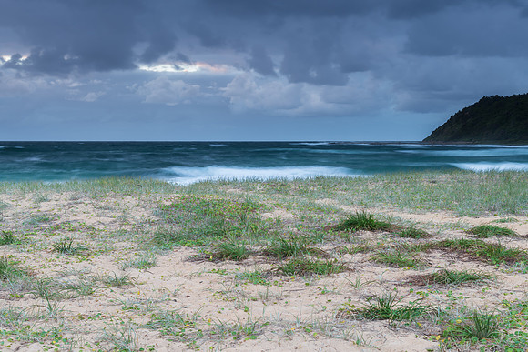 Moody morning bay seascape with rain clouds
