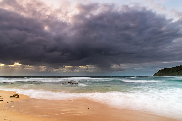 Moody morning bay seascape with rain clouds