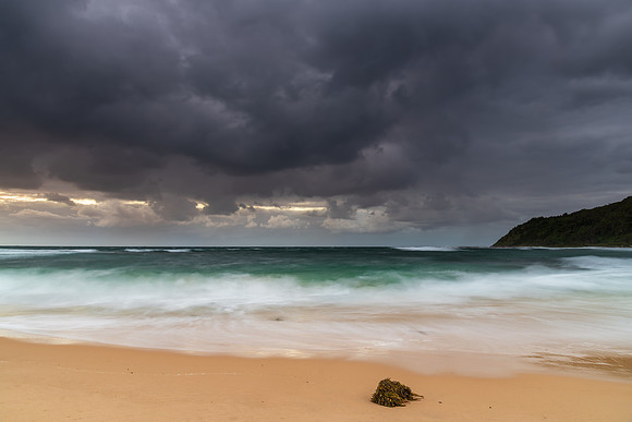 Moody morning bay seascape with rain clouds