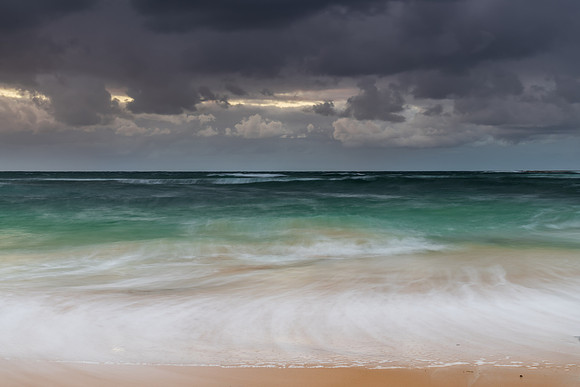 Moody morning bay seascape with rain clouds