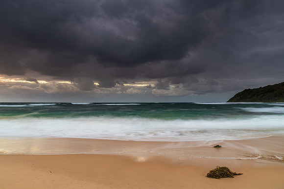 Moody morning bay seascape with rain clouds