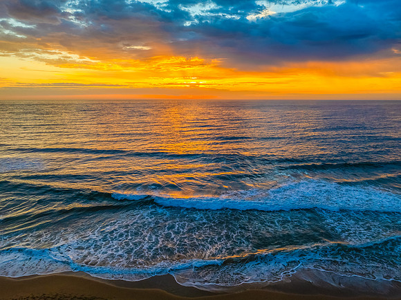 Pretty Sunrise at the seaside with rain clouds