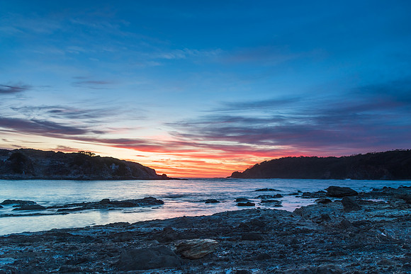Colourful High Cloud Sunrise Seascape and Rock Formations