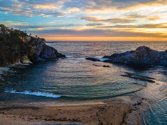 Colourful High Cloud Sunrise Seascape and Rock Formations