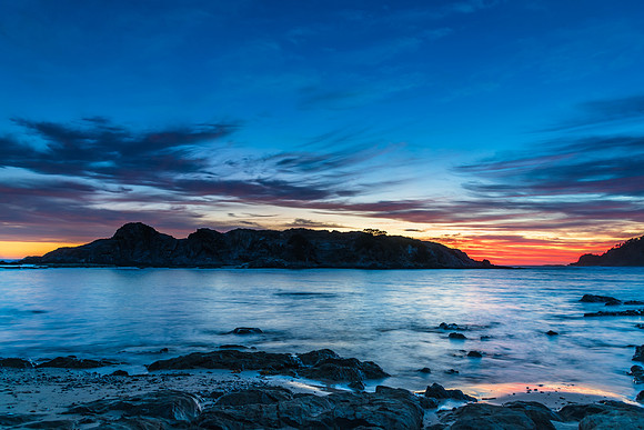Colourful High Cloud Sunrise Seascape and Rock Formations