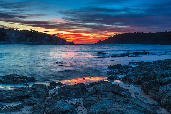 Colourful High Cloud Sunrise Seascape and Rock Formations