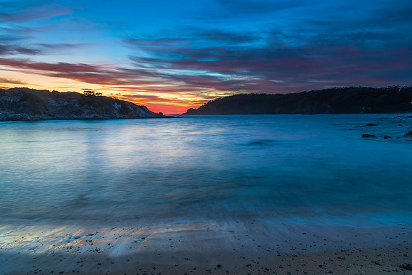 Colourful High Cloud Sunrise Seascape and Rock Formations