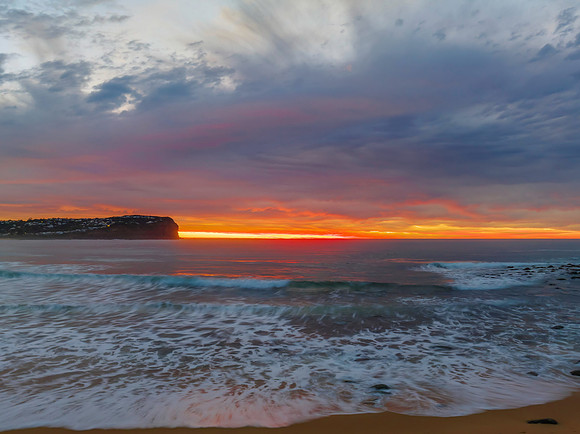 Cloud filled sunrise seascape