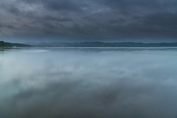 Rainy day early morning waterscape at the lake
