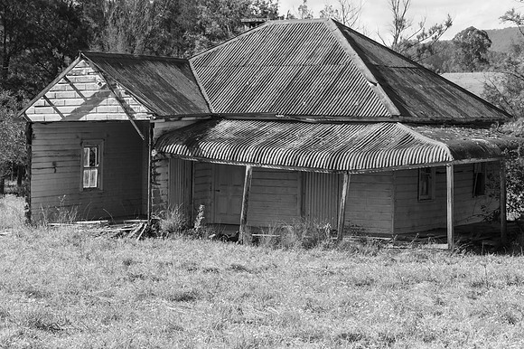 Rural landscape with old derelict house and rolling hills