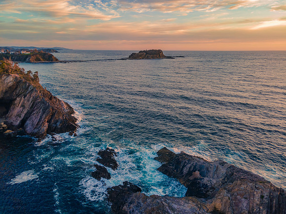 Colourful High Cloud Sunrise Seascape and Rock Formations