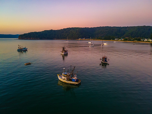 Boats at rest and gentle sunrise over the bay