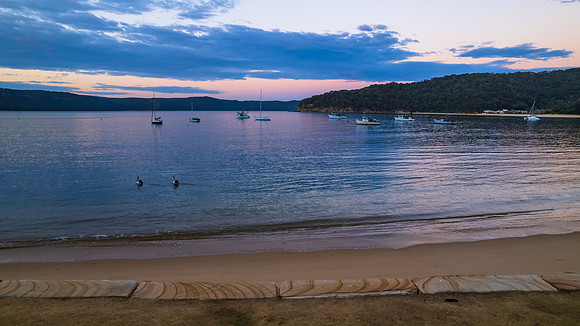 Peaceful sunrise over the bay with boats
