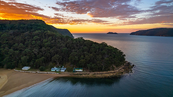 Peaceful sunrise over the bay with mountains