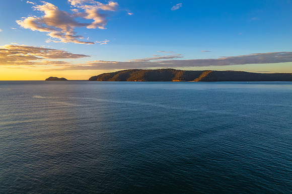 Peaceful sunrise over the bay with boats