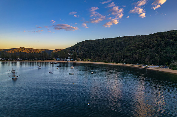 Peaceful sunrise over the bay with boats