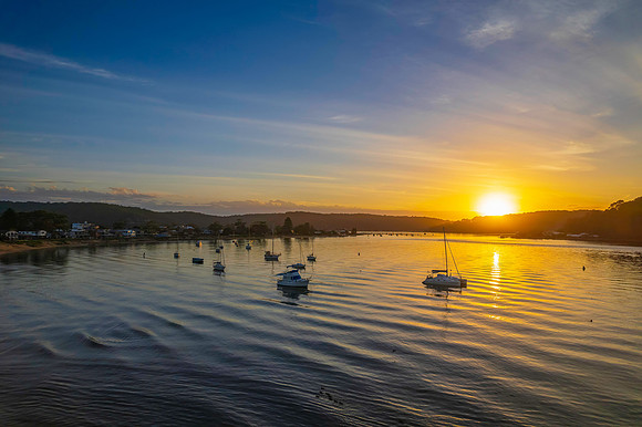 Aerial sunrise waterscape with boats
