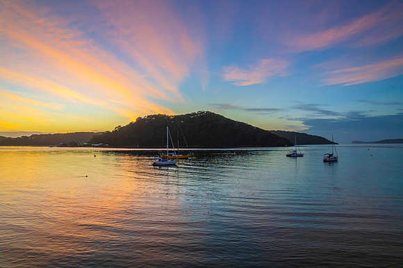 Aerial sunrise waterscape with boats