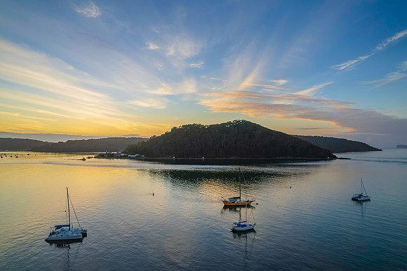 Aerial sunrise waterscape with boats