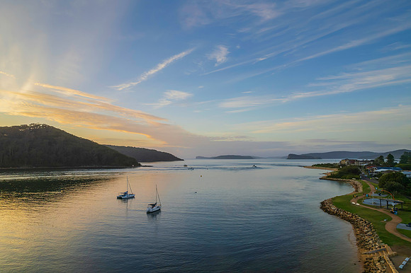 Aerial sunrise waterscape with boats