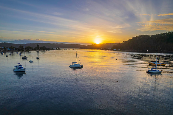 Aerial sunrise waterscape with boats