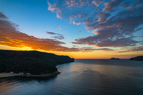 Peaceful sunrise over the bay with boats