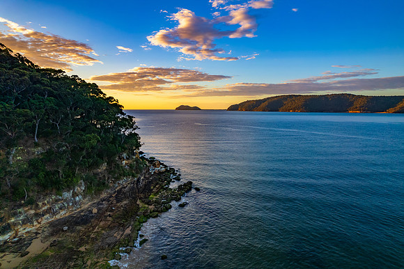 Peaceful sunrise over the bay with boats