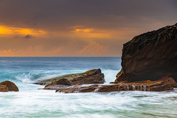 Sunrise at the seaside with rocks