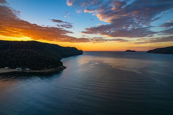 Peaceful sunrise over the bay with boats