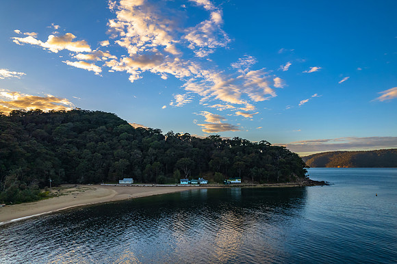 Peaceful sunrise over the bay with boats