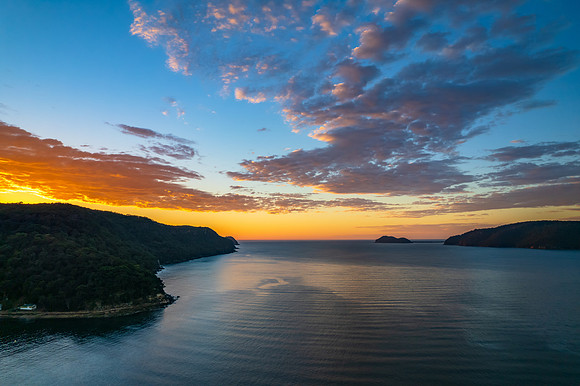 Peaceful sunrise over the bay with boats