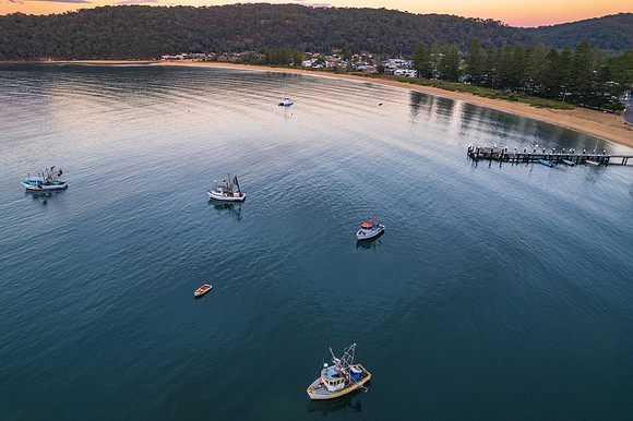 Peaceful sunrise over the bay with boats