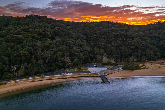 Peaceful sunrise over the bay with boats