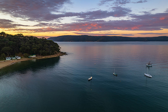 Peaceful sunrise over the bay with boats