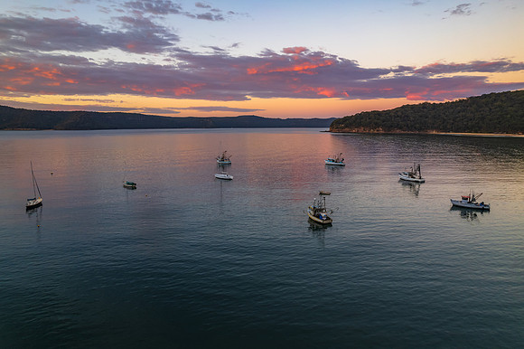 Peaceful sunrise over the bay with boats