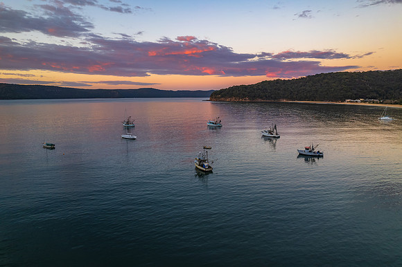 Peaceful sunrise over the bay with boats