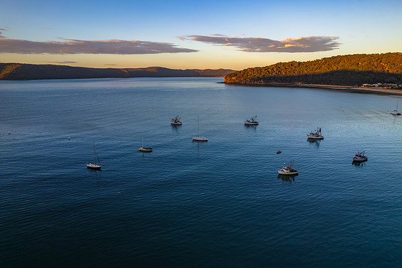 Peaceful sunrise over the bay with boats