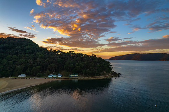 Peaceful sunrise over the bay with boats