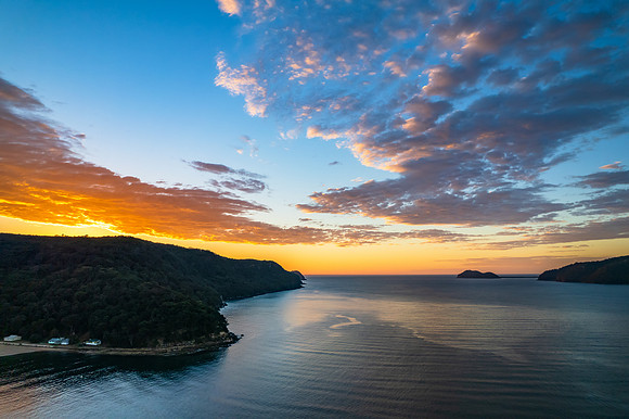 Peaceful sunrise over the bay with boats