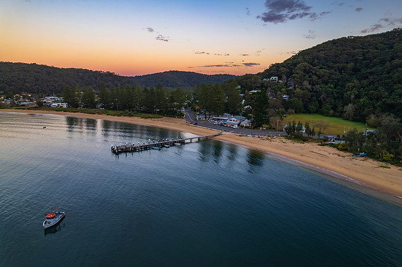Peaceful sunrise over the bay with boats