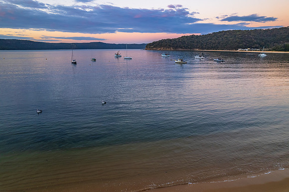 Peaceful sunrise over the bay with boats