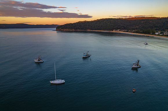 Peaceful sunrise over the bay with boats