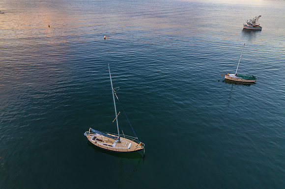 Peaceful sunrise over the bay with boats