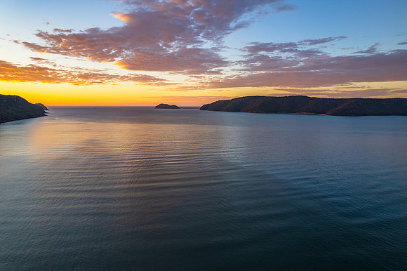 Peaceful sunrise over the bay with boats